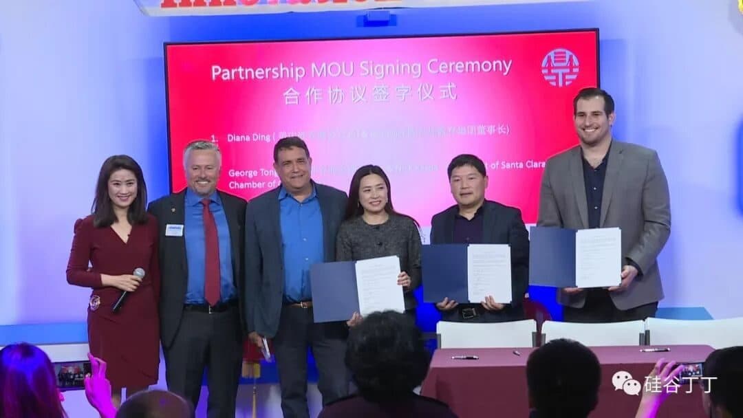 六位代表在写有"Partnership MOU Signing Ceremony 合作协议签字仪式"的屏幕前手持签署好的文件夹。